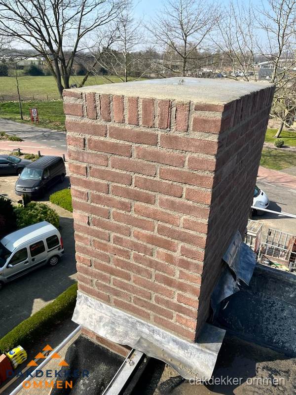 Gemetselde schoorsteen met loodaansluiting op dak in Ommen Gemetselde schoorsteen met loodaansluiting op dak in Ommen